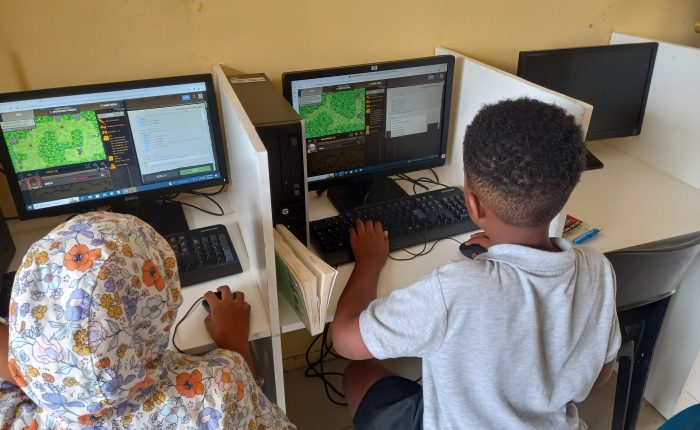 Kids in computer lab coding